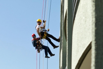 Two painters doing hope access in a building