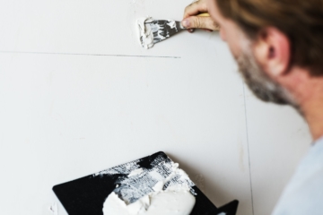 Solid plaster being repaired on wall